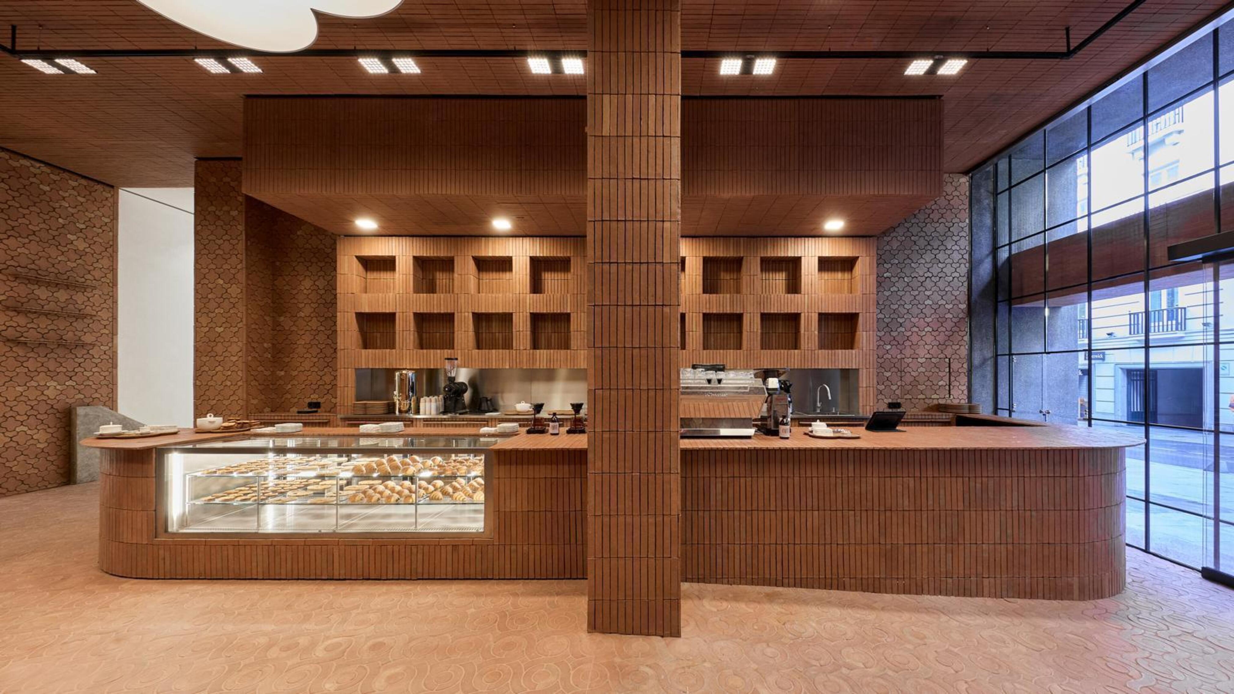 Zacaffè interior at Zara Hermosilla in Madrid, with wooden textures, a central service counter, and a clean, architectural design aesthetic.